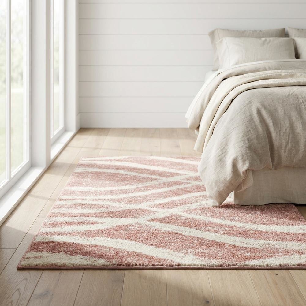 Cream and rose area rug with power loomed polypropylene pile in accent shape
