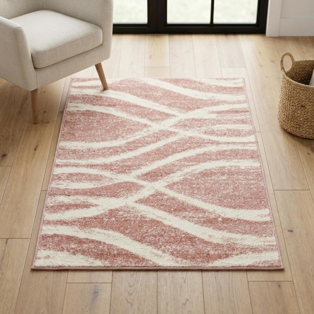 Cream and rose area rug with power loomed polypropylene pile in accent shape
