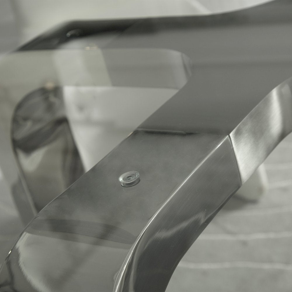 Designer Louis Lara's Cirrus table has polished base connector with brushed stainless steel and 15mm Tempered glass Top Smoke