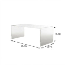 Clear acrylic coffee table with sleek design and lightweight build