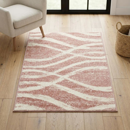 Cream and rose area rug with power loomed polypropylene pile in accent shape