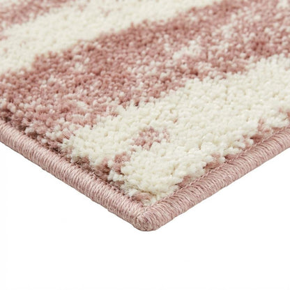 Cream and rose area rug with power loomed polypropylene pile in accent shape