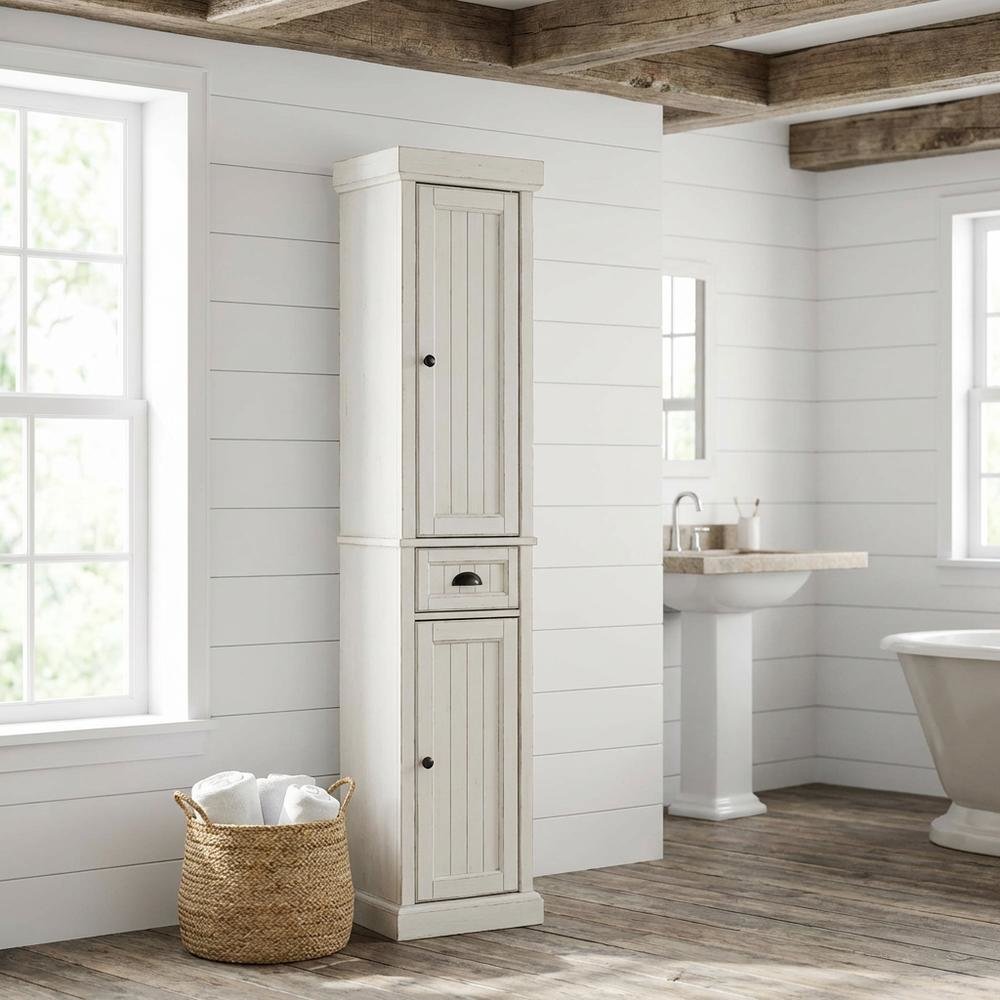 Tall linen cabinet in distressed white with anti-tip hardware