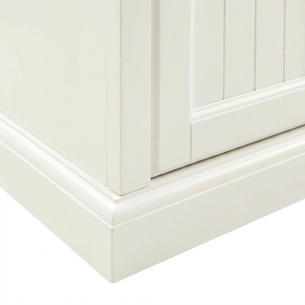 Tall linen cabinet in distressed white with anti-tip hardware