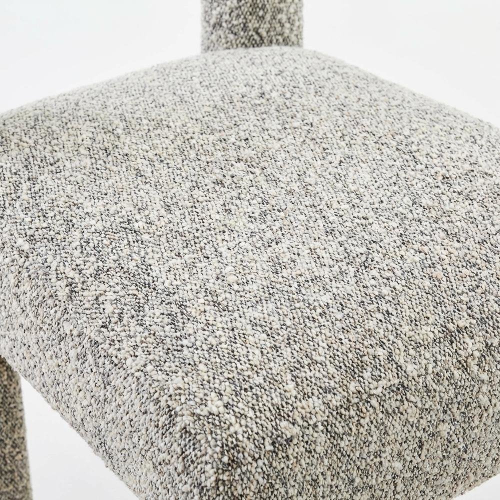 Gray boucle fabric dining chair with fiber-wrapped foam seat and plywood support