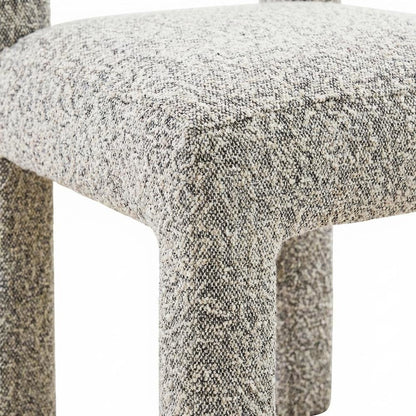 Gray boucle fabric dining chair with fiber-wrapped foam seat and plywood support