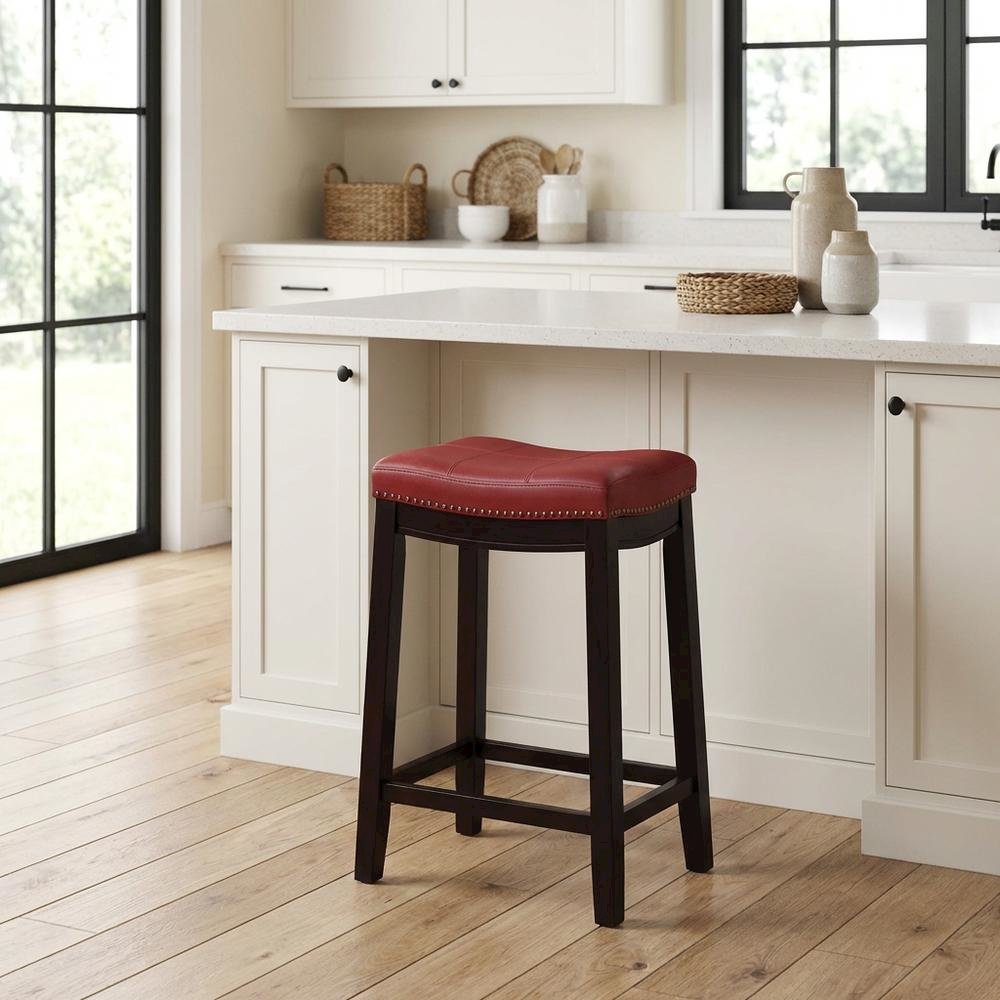 Red counter stool with rubberwood frame and cushioned faux leather seat
